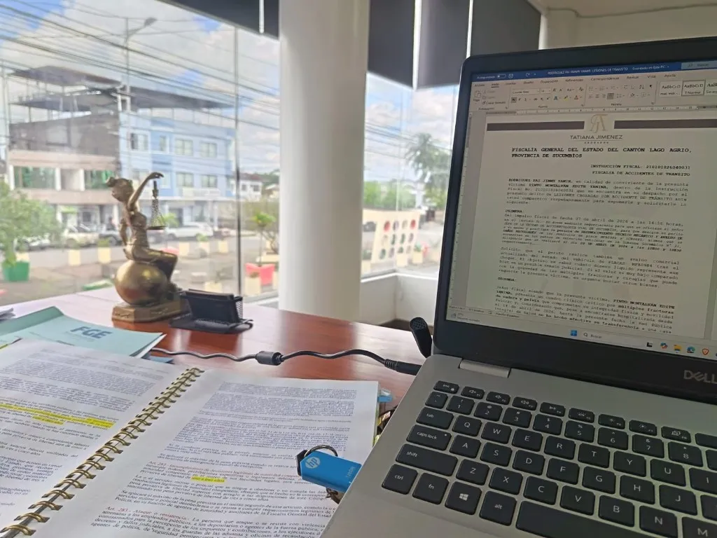 Escritorio de trabajo con un expediente de tránsito y códigos legales